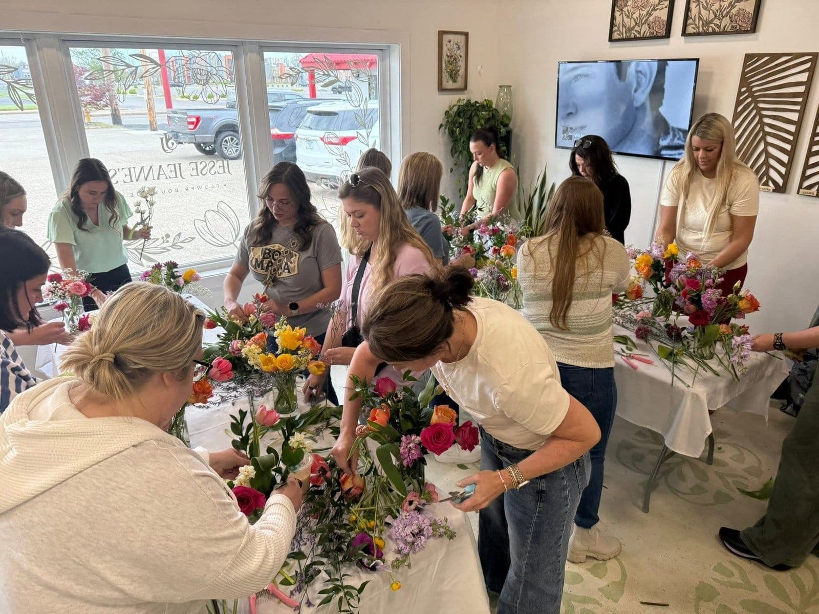A full room of people building their own arrangements at a Jesse Jeanne's make-and-take class