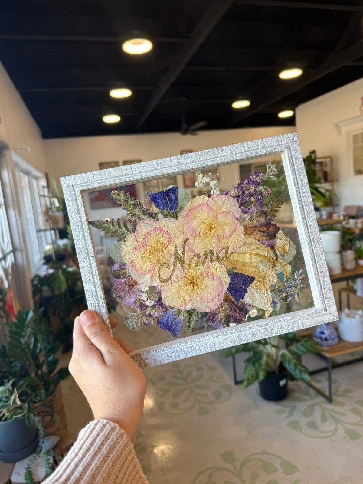 Preserved flower keepsake pressed into a frame and lettered with the word Nana