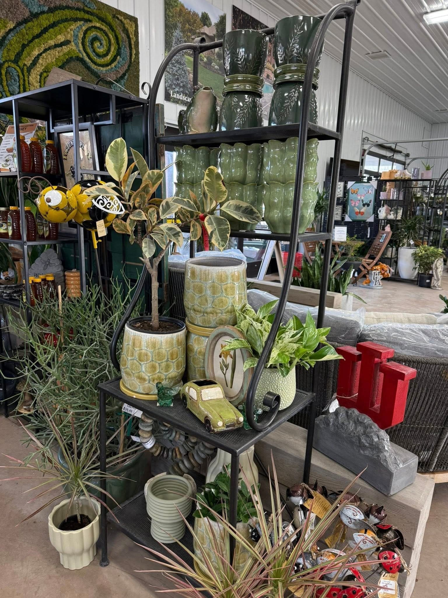 Green pottery, watering cans, and decorative accessories on display