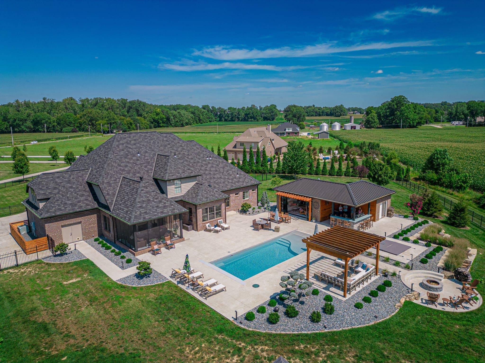 Beautifully landscaped property with patio, lush plantings, and outdoor living space
