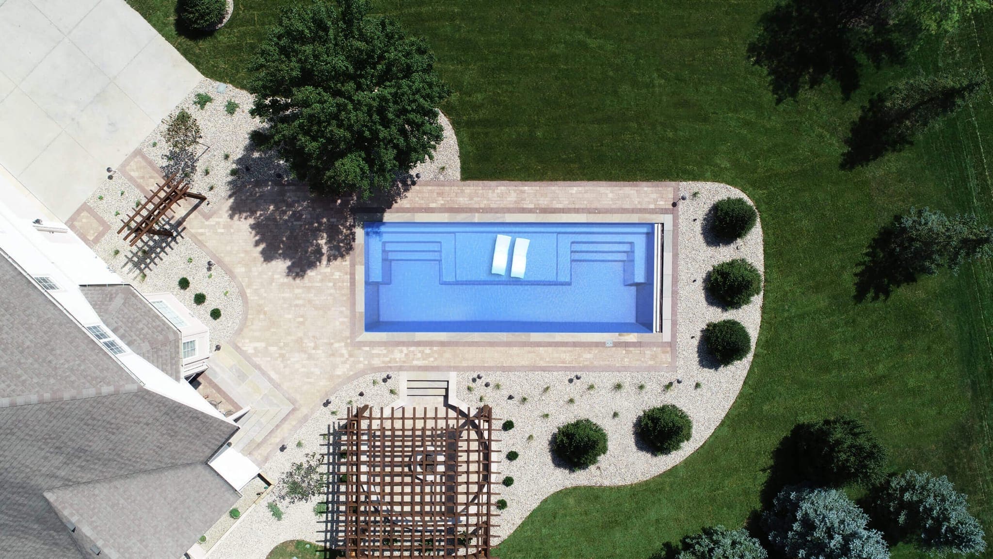 Magnate rectangular fiberglass pool with tanning ledge aerial view
