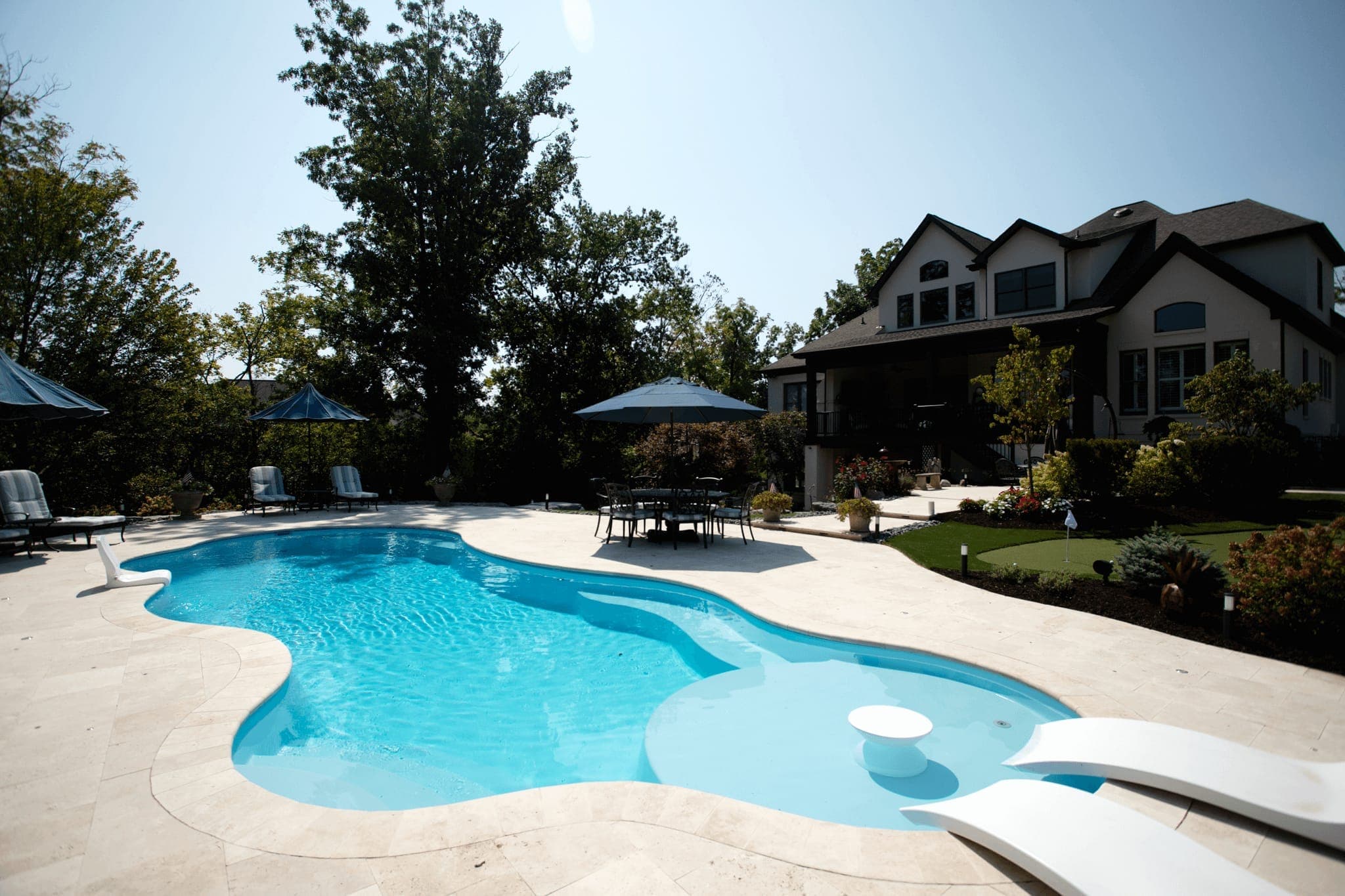 Wellspring freeform fiberglass pool with slide-compatible deep end