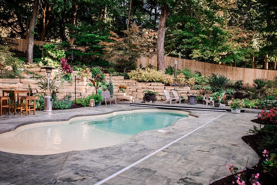 Family-friendly pool with natural stone decking and landscape surroundings