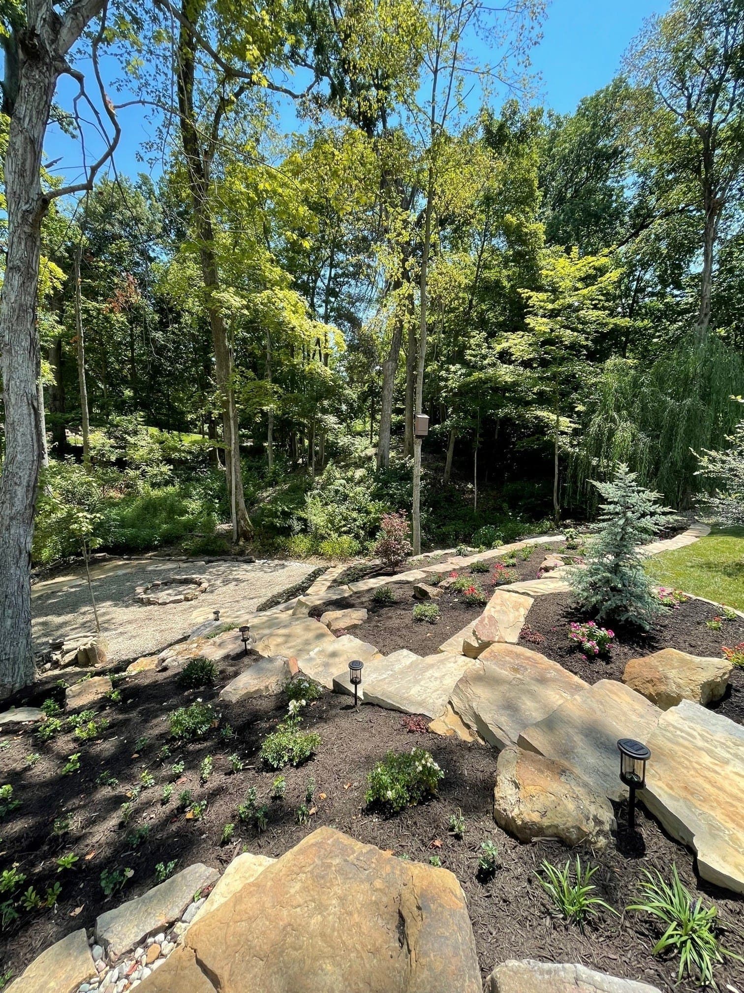 Natural stone steps integrated into hillside landscaping