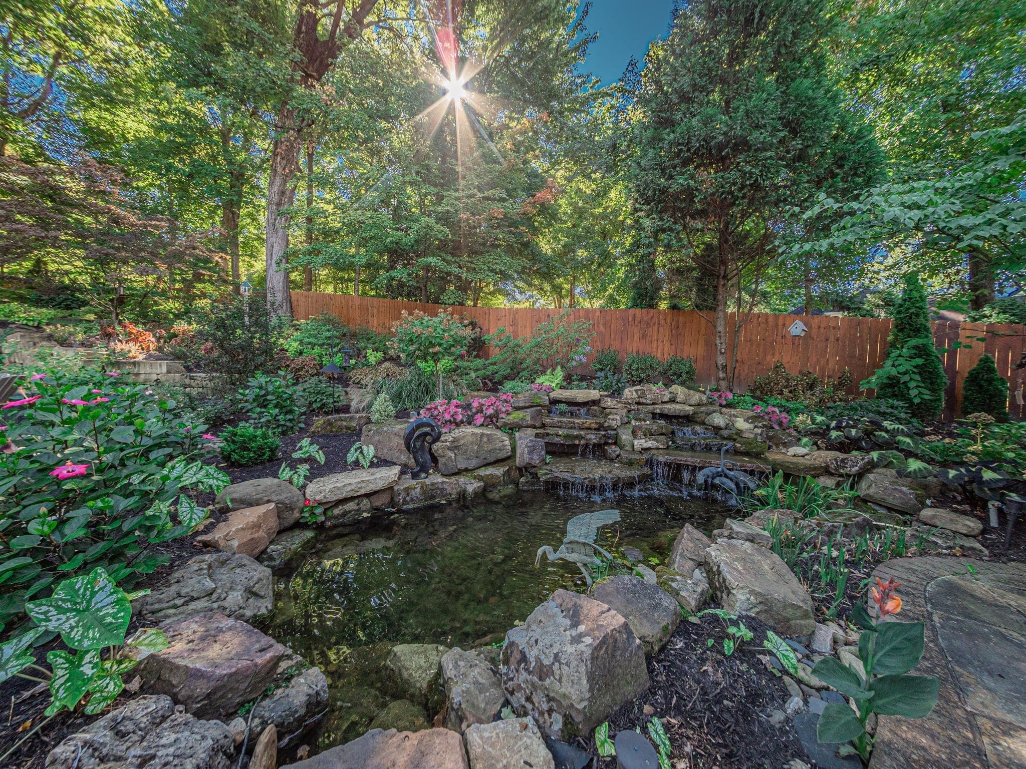 Custom pond with natural stone edging and aquatic plantings